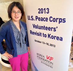 Kristin Krzic in front of a sign for the Peace Corps
