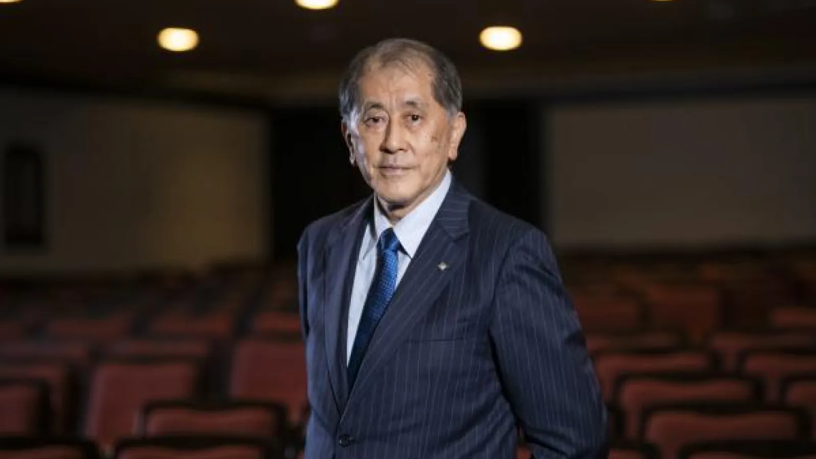 Aiji Tanaka in front of an empty theatre