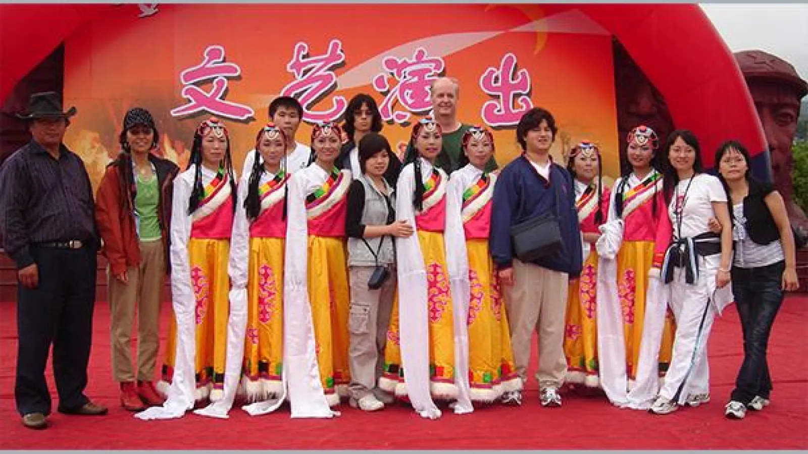 "Professor Mark Bender and a group of students pose with a Tibetan dance troupe"