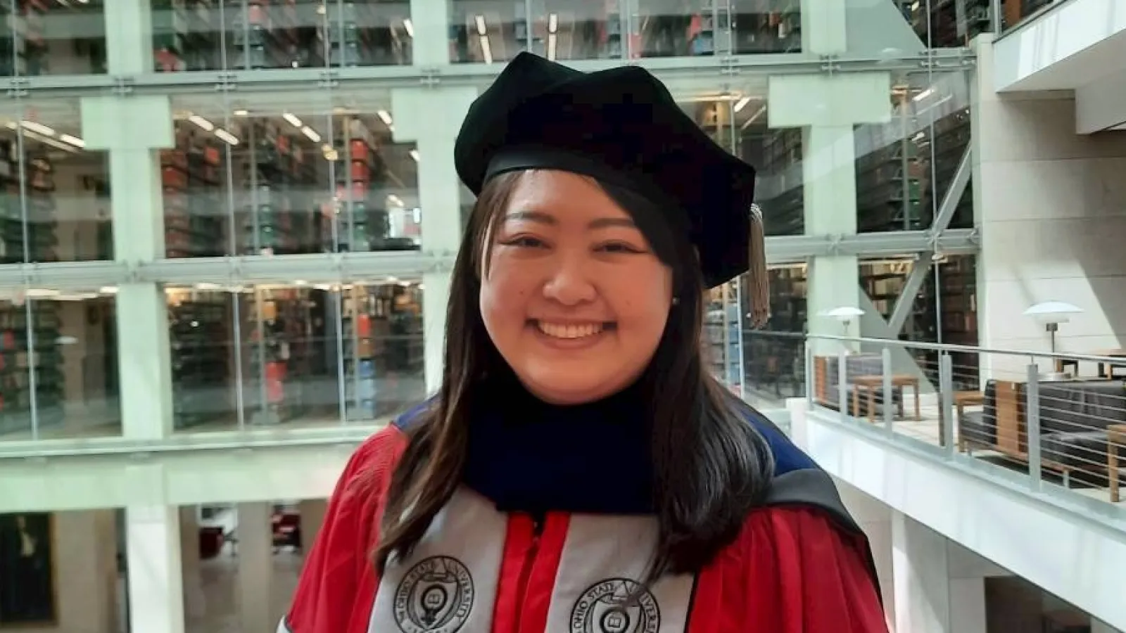 Smiling woman in graduation regalia 