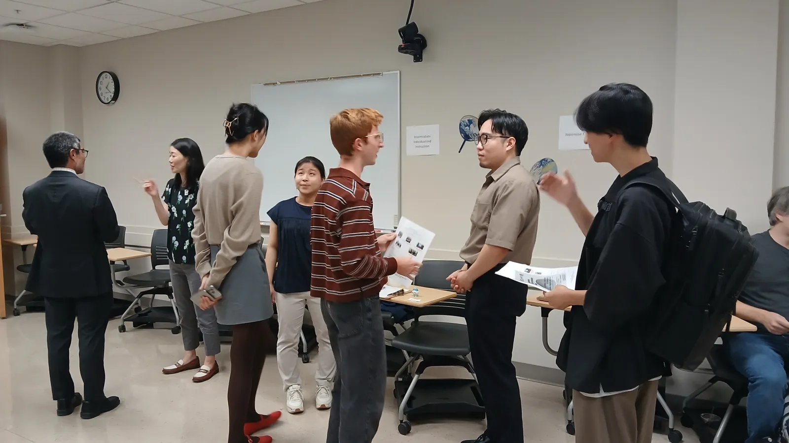 Several people standing in a circle and talking