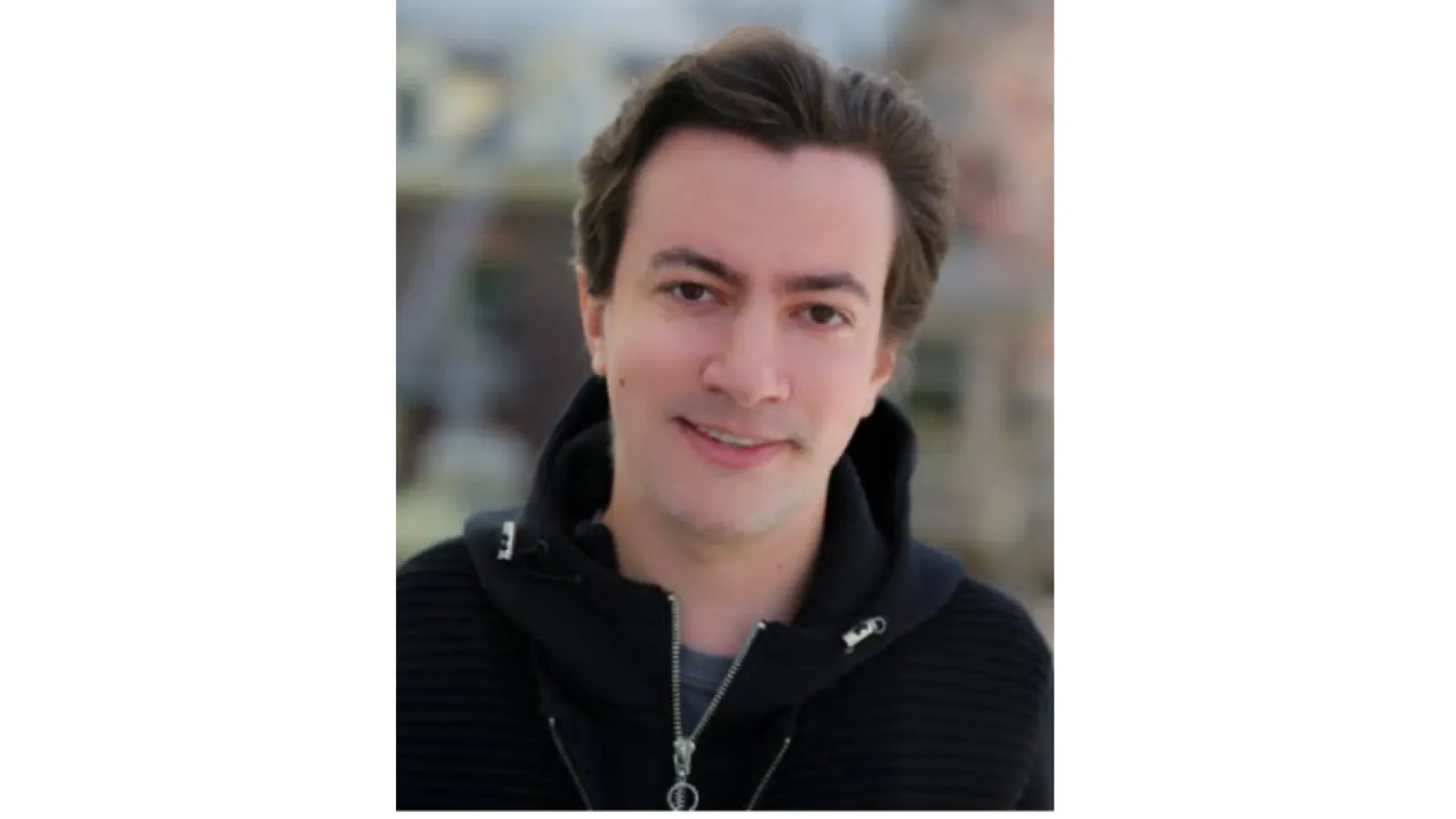 Man with dark hair and a black jacket