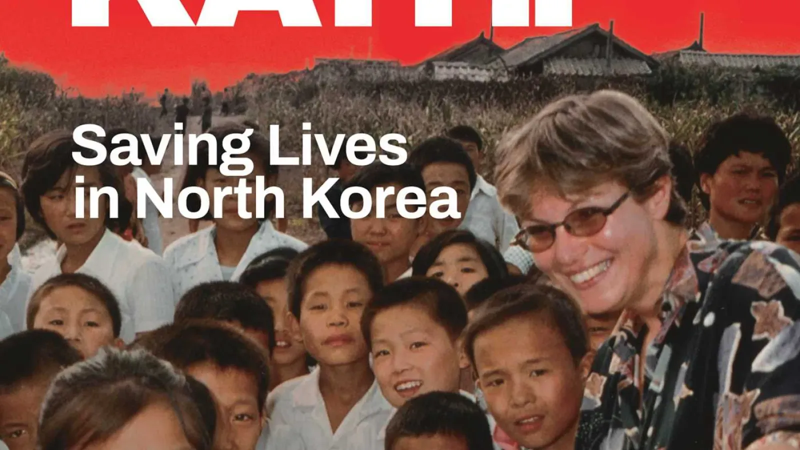 Smiling woman with sunglasses surrounded by children, with the overlaid title “Saving Lives in North Korea.”