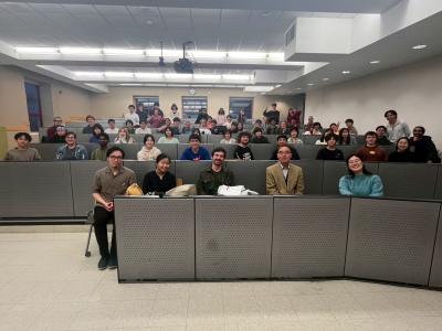 A classroom scene featuring a group of students attentively listening and participating  