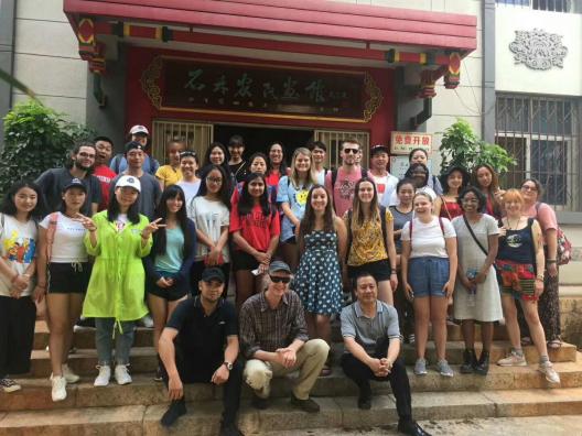 Prof. Mark Bender, his counterpart Prof. Luo Qingchun (right, aka Aku Wuwu), Mr. Bi, the museum director (left) and the 2019 education abroad participants visiting an ethnic culture museum in Shilin, Yunnan province. 