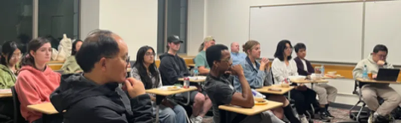 Scene of peopel in a classroom focused on the speaker