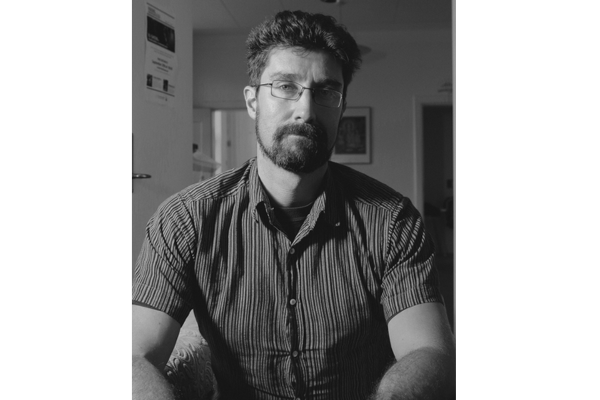 A bearded man wearing glasses seated in a chair (Ryan Holmberg)