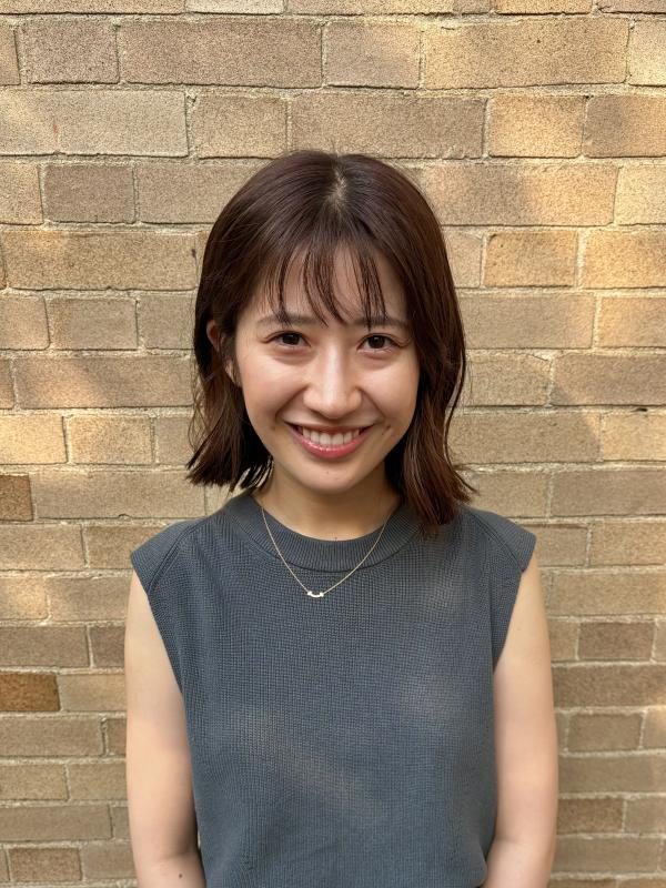 Smiling woman wearing dark sweater 