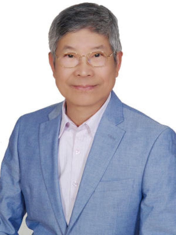 James Tai wearing blue suit and eyeglasses
