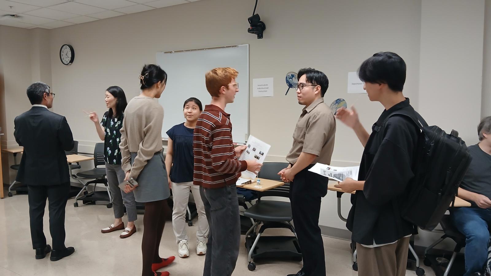 Several people standing in a circle and talking